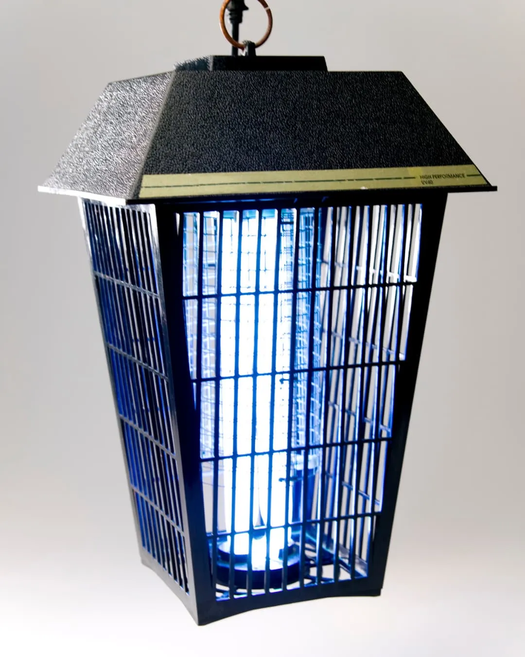 A black insect trap with a glowing blue light hangs against a gray background. The top reads "High Performance VIVID."