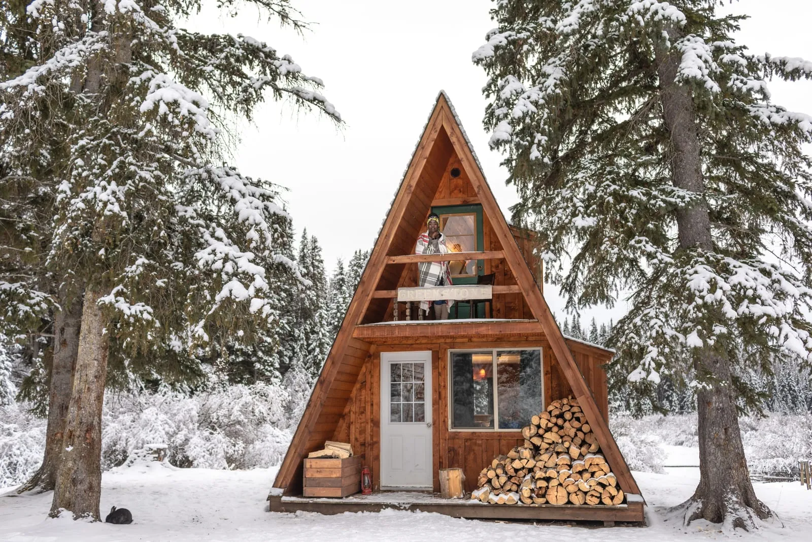 A-frame cabin in a snowy mountain scene