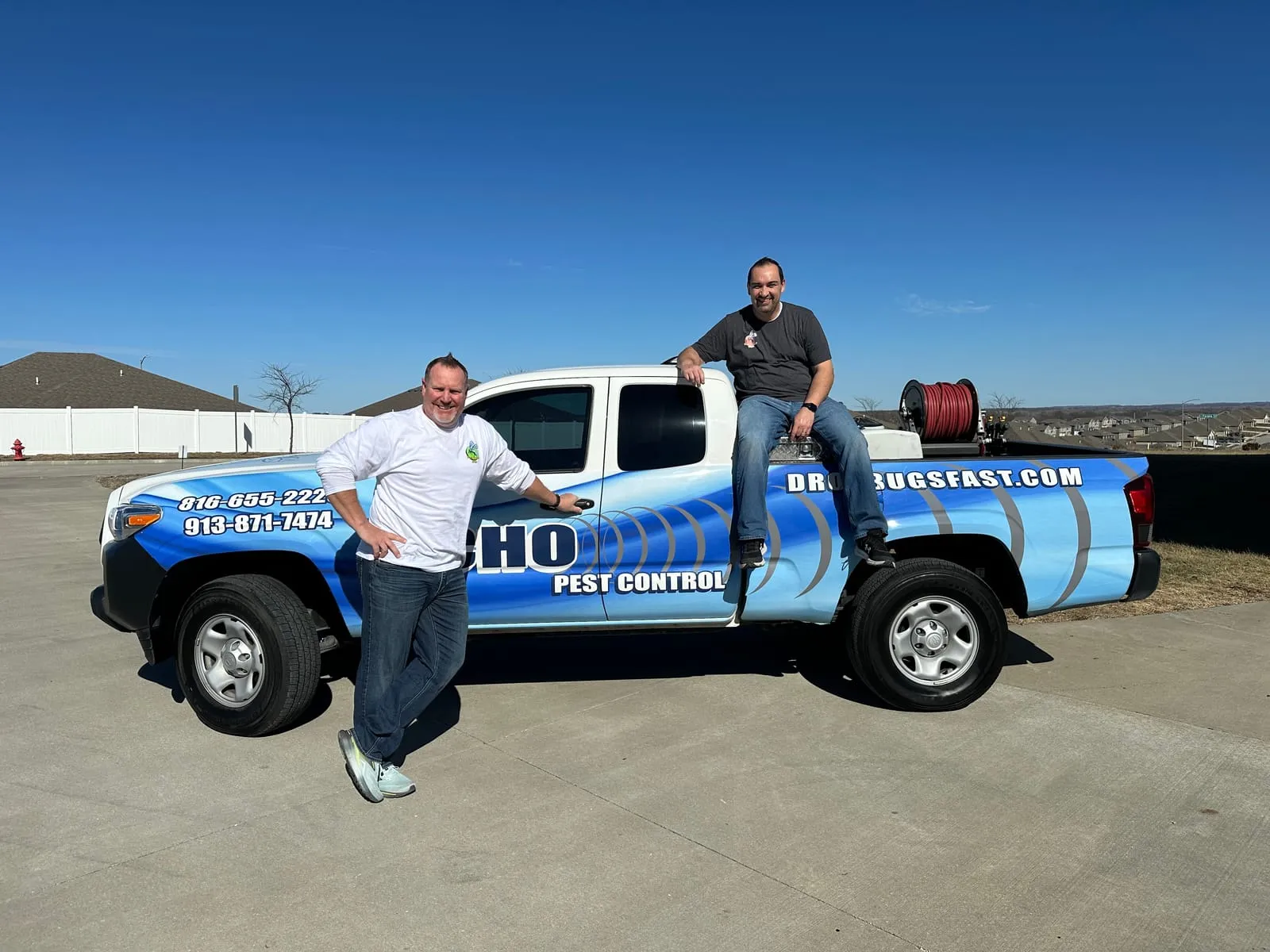 The founders with one of their pest-control service trucks